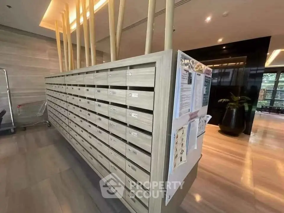 Modern apartment building lobby with stylish mailboxes and elegant decor.