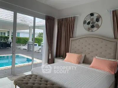 Luxurious bedroom with pool view, elegant decor, and large windows in a modern home.