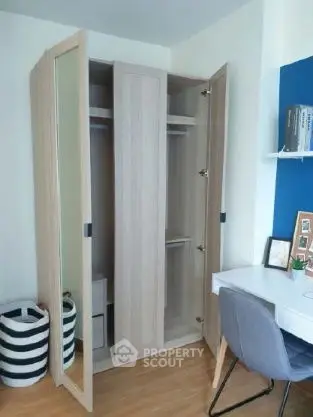Modern study room with open wardrobe and stylish desk chair