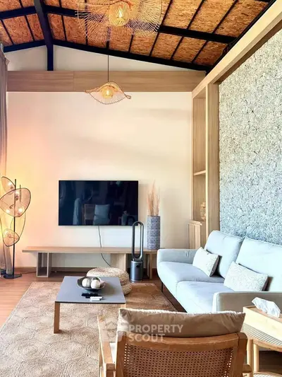 Stylish living room with modern decor, cozy seating, and elegant lighting in a contemporary home.