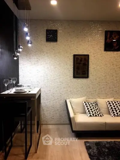 Stylish modern living room with elegant lighting and cozy seating area, perfect for relaxation and entertaining.