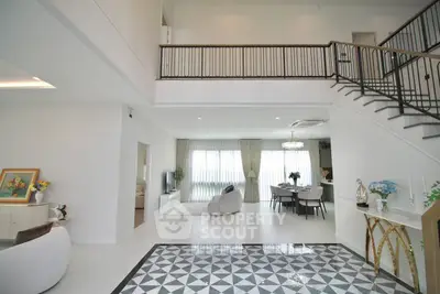 Spacious modern living room with elegant staircase and open dining area