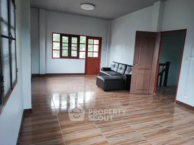 Spacious living room with modern sofa and large windows for natural light