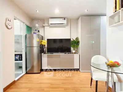 Modern living room with sleek TV unit and stylish decor in a cozy apartment.