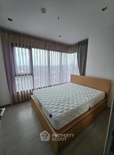 Spacious bedroom with large windows and modern decor