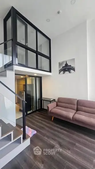 Modern loft-style living room with high ceilings and stylish decor