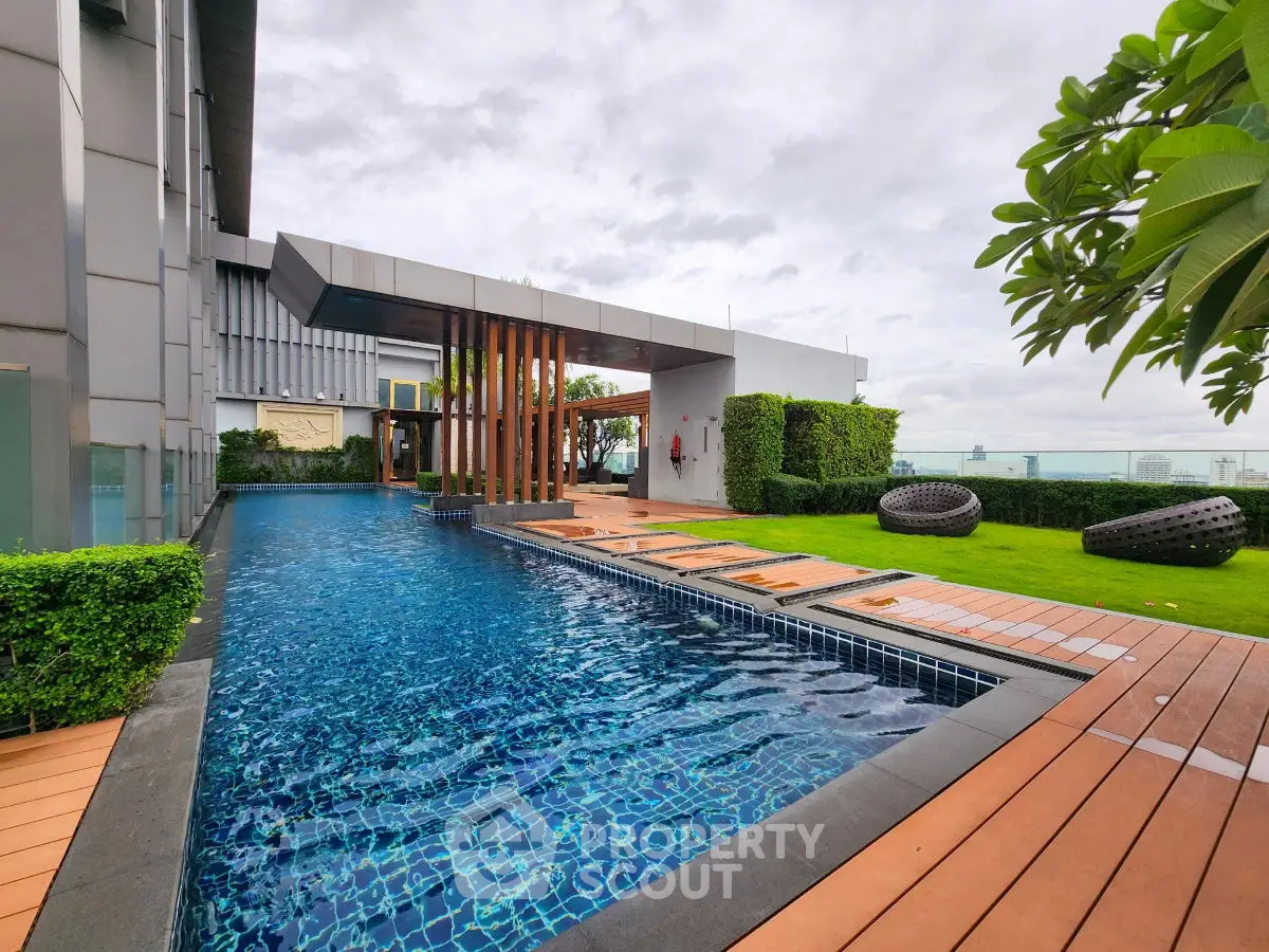 Luxurious rooftop pool with modern design and lush greenery