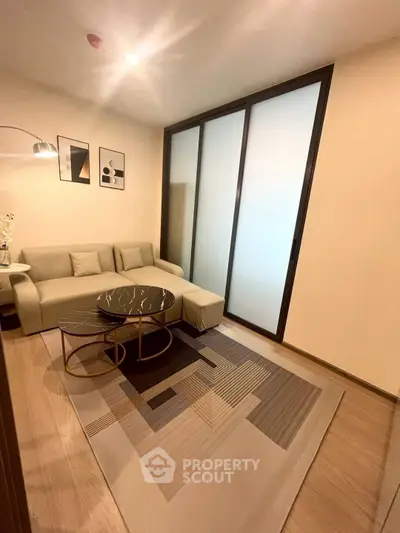 Modern living room with stylish decor and cozy seating area, perfect for relaxation.