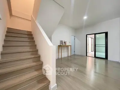 Spacious modern interior with wooden staircase and open living area