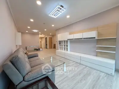 Spacious modern living room with sleek furniture and ambient lighting