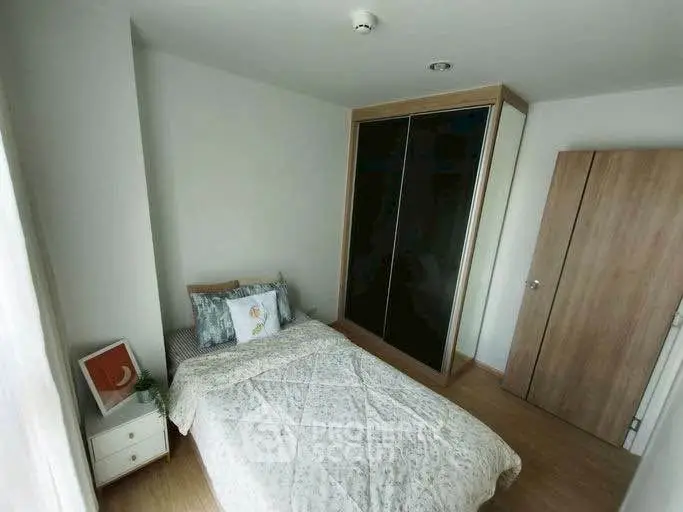 Cozy bedroom with modern wardrobe and stylish decor in a bright apartment.