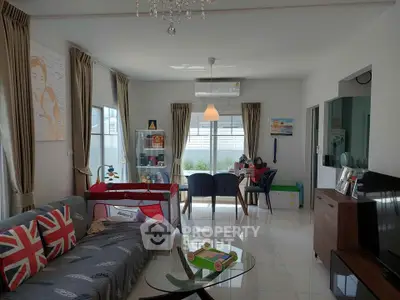 Spacious living room with modern decor and ample natural light