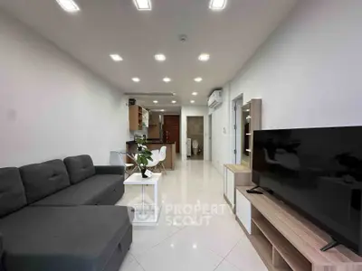Modern living room with sleek furniture and open kitchen layout, perfect for contemporary living.