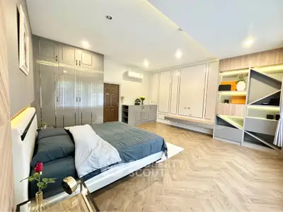 Spacious modern bedroom with elegant decor and ample storage space.