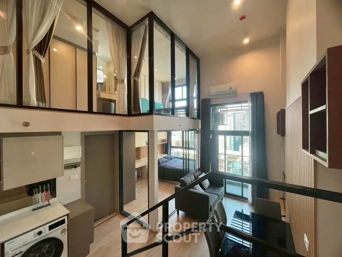 Modern loft apartment with high ceilings, large windows, and stylish interior design in urban setting.