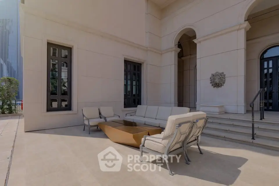 Elegant outdoor seating area with modern furniture and architectural details.