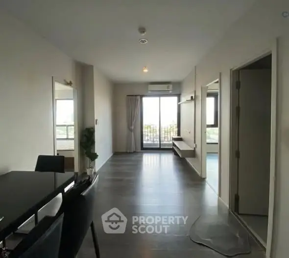 Spacious modern apartment with open layout and large windows offering natural light.