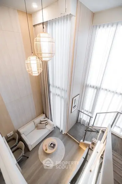 Stunning modern living room with high ceilings and elegant decor in a luxury apartment.