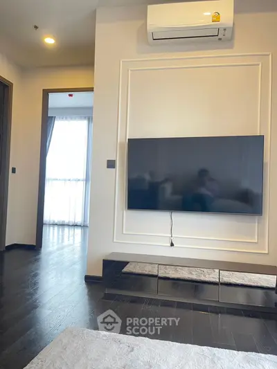 Modern living room with wall-mounted TV and air conditioning unit