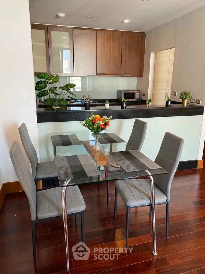 Modern dining area with glass table and stylish chairs in open kitchen layout
