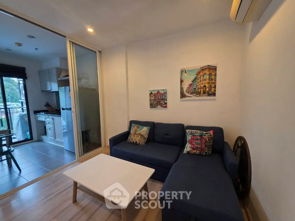 Cozy living room with modern decor and open kitchen layout