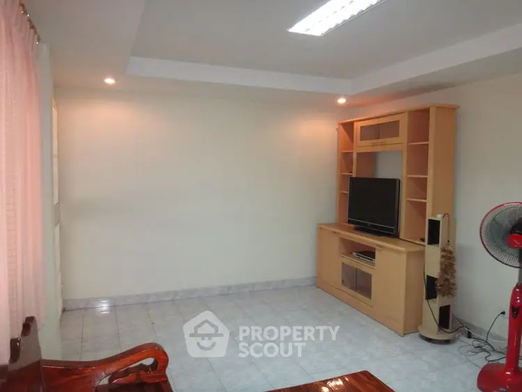 Spacious living room with modern TV unit and tiled flooring