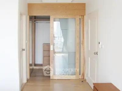 Spacious walk-in closet with sliding glass door in modern apartment