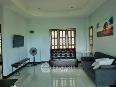 Spacious living room with modern decor and natural light