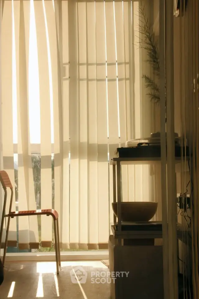 Bright interior space with vertical blinds and modern furniture, ideal for a cozy living area.