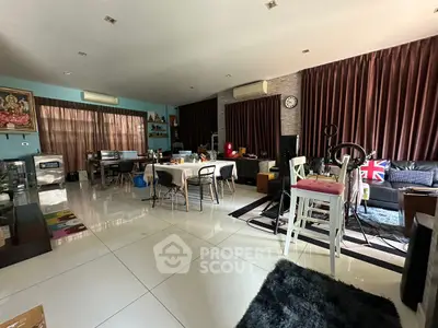 Spacious living room with modern decor and ample natural light, perfect for family gatherings.