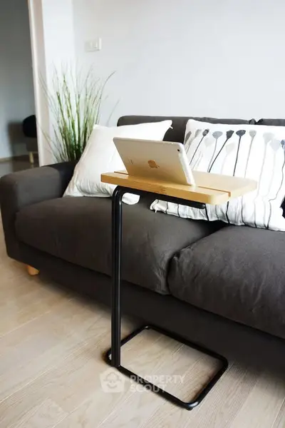 Modern living room with stylish sofa and sleek tablet stand