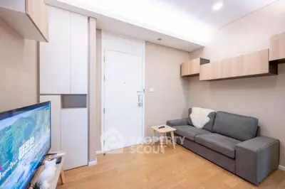 Modern living room with sleek design and cozy sofa in a compact space.