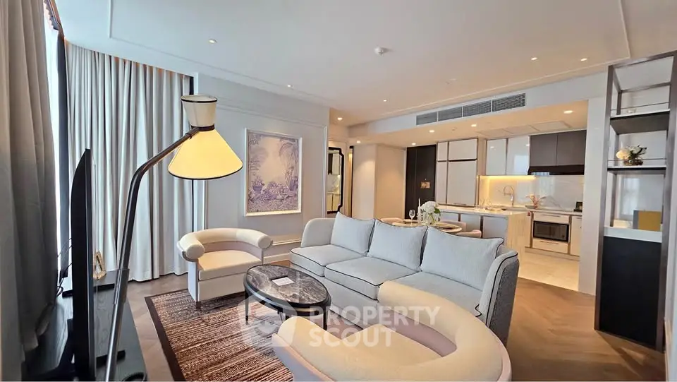 Luxurious modern living room with elegant furniture and open kitchen layout in high-end apartment.