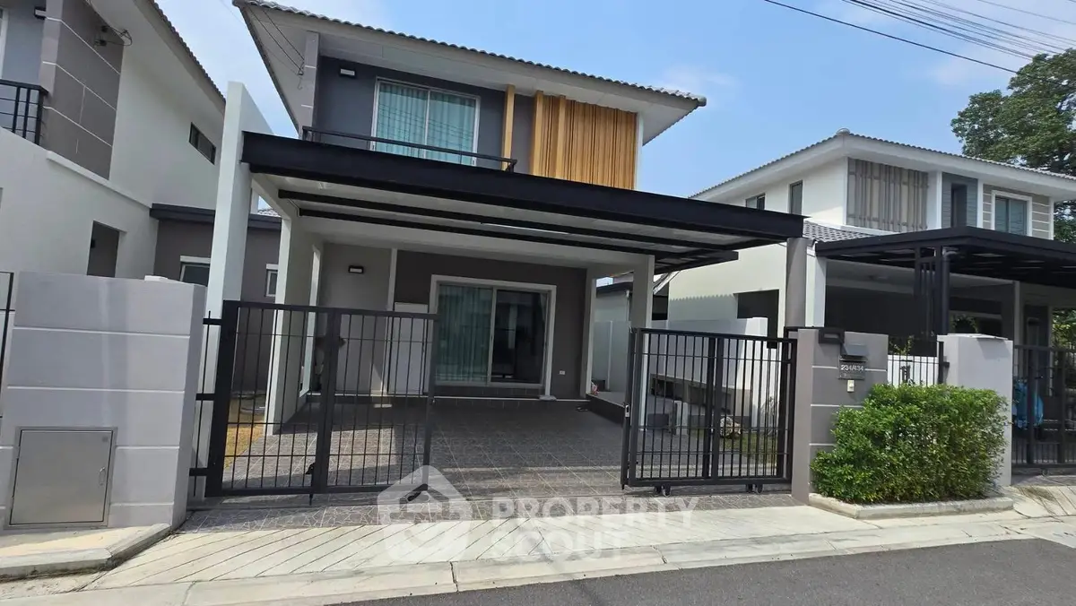 Modern two-story house with gated driveway and contemporary design