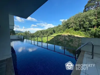 Luxurious infinity pool with stunning forest view, perfect for relaxation and leisure in a serene setting.