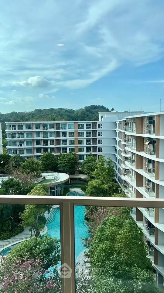 Stunning view of modern apartment complex with lush greenery and inviting pool area.