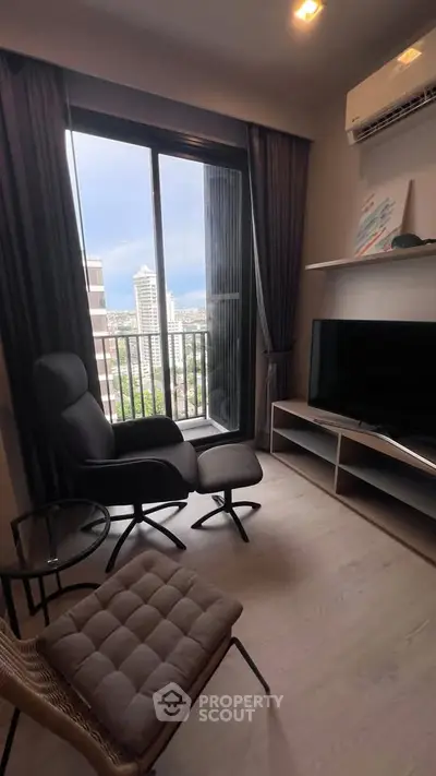 Modern living room with city view, featuring sleek furniture and large window.