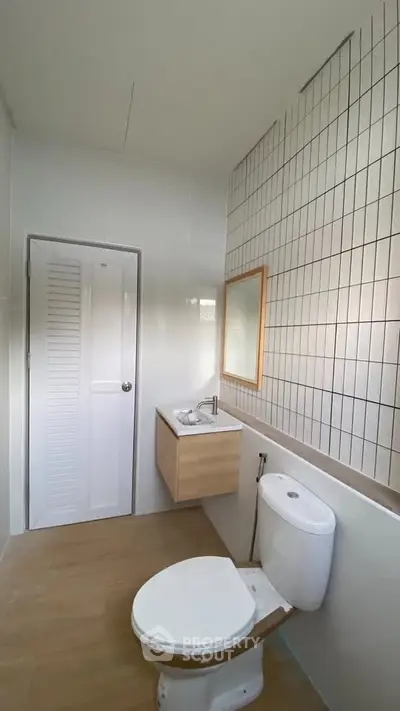Modern bathroom with sleek design and wooden accents