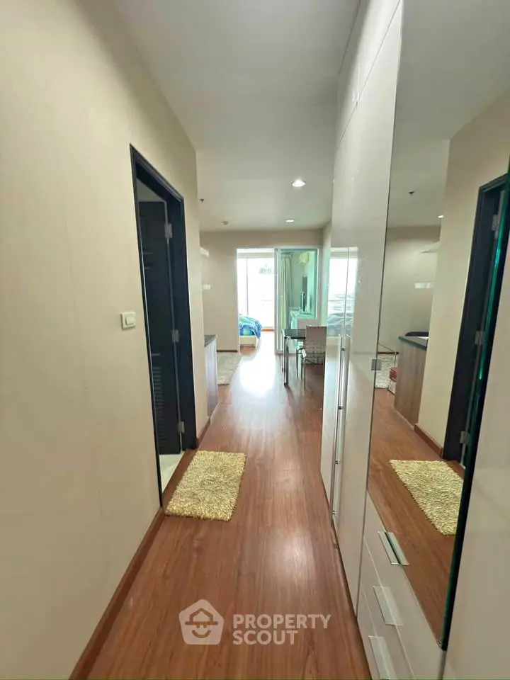 Modern apartment hallway with wooden flooring and sleek design