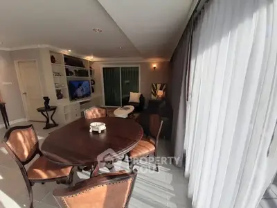Elegant living room with round dining table and large windows for natural light