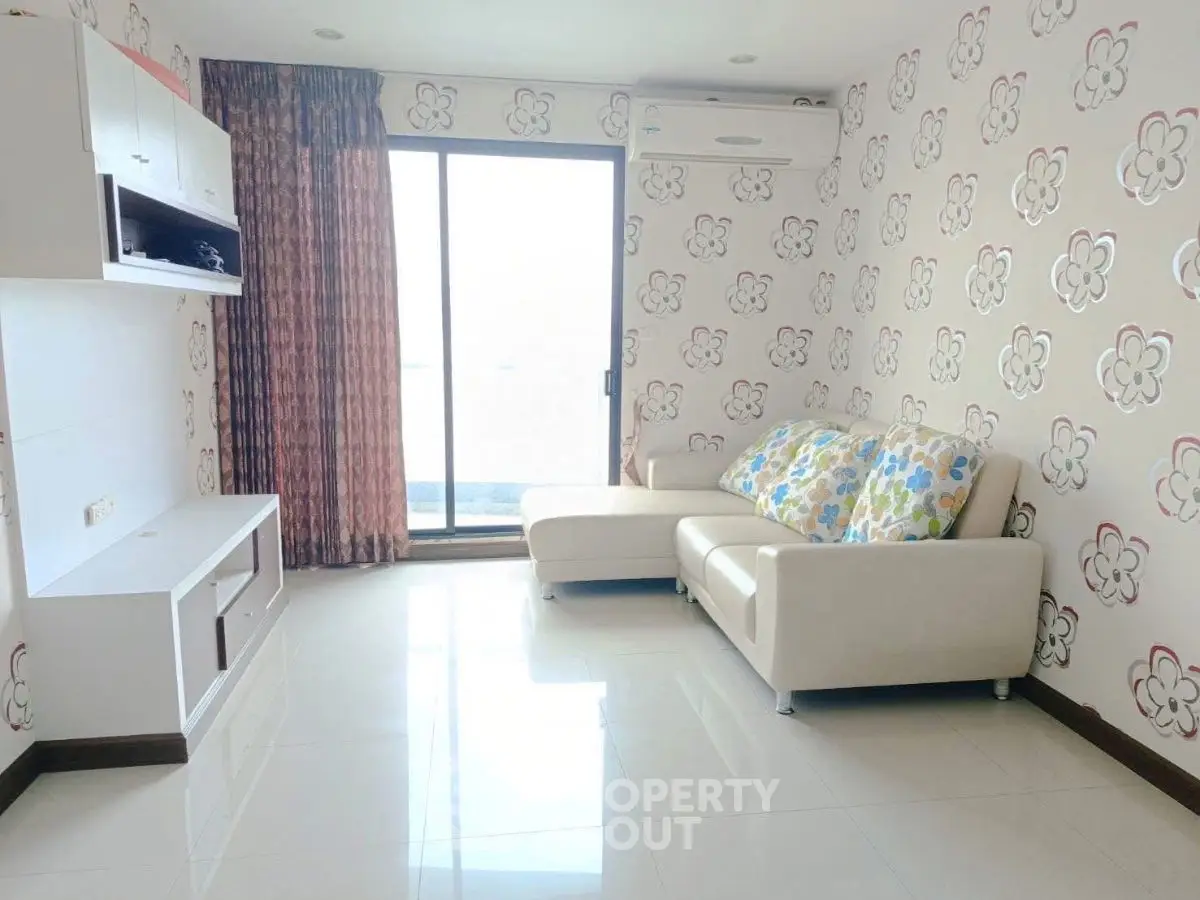 Bright living room with floral wallpaper and modern furniture in a stylish apartment.