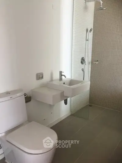 Modern bathroom with sleek fixtures and glass shower enclosure