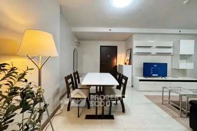 Modern living room with dining area, stylish furniture, and ambient lighting.