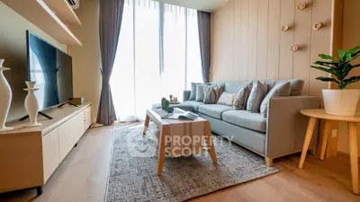 Stylish modern living room with cozy sofa, large TV, and elegant decor, perfect for relaxation and entertainment.