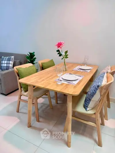 Modern dining area with wooden table and stylish chairs in a cozy living space.