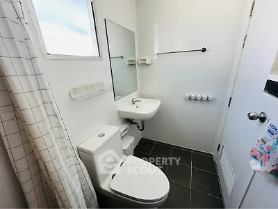 Compact modern bathroom with white tiles and sleek fixtures