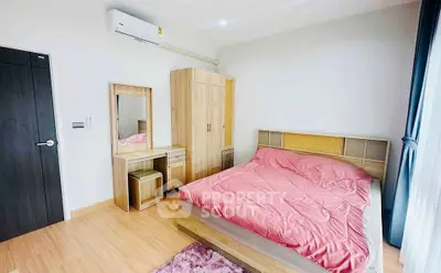 Spacious bedroom with modern furniture and natural light, featuring a cozy bed and wooden wardrobe.