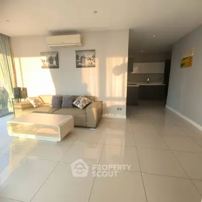 Modern living room with sleek furniture and natural light in a stylish apartment.