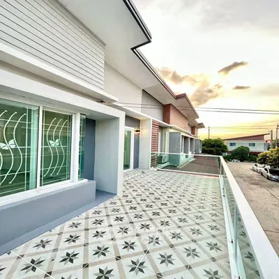 Modern townhouse exterior with stylish balcony and sunset view