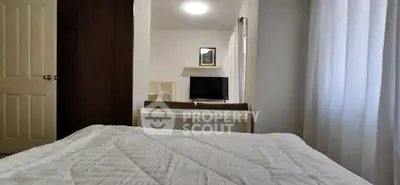 Cozy bedroom with modern decor and natural light, featuring a comfortable bed and stylish furnishings.